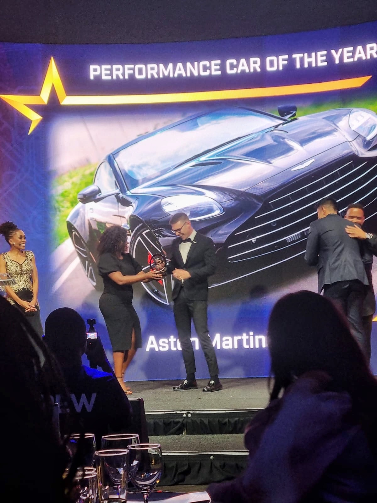 Performance Car of the Year award being presented in front of an Aston Martin display