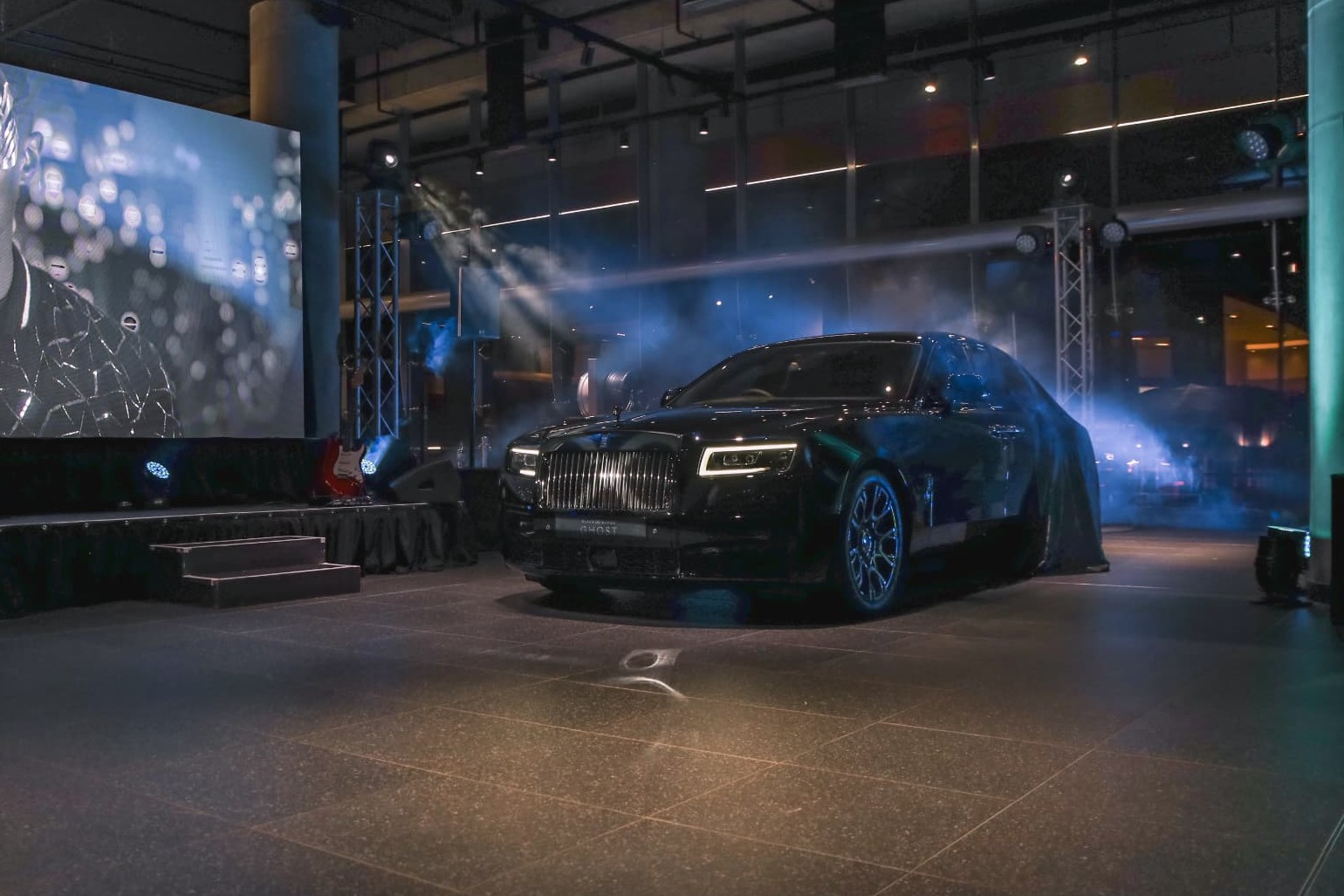 Black Badge Ghost revealed under blue stage lighting beside the launch screen