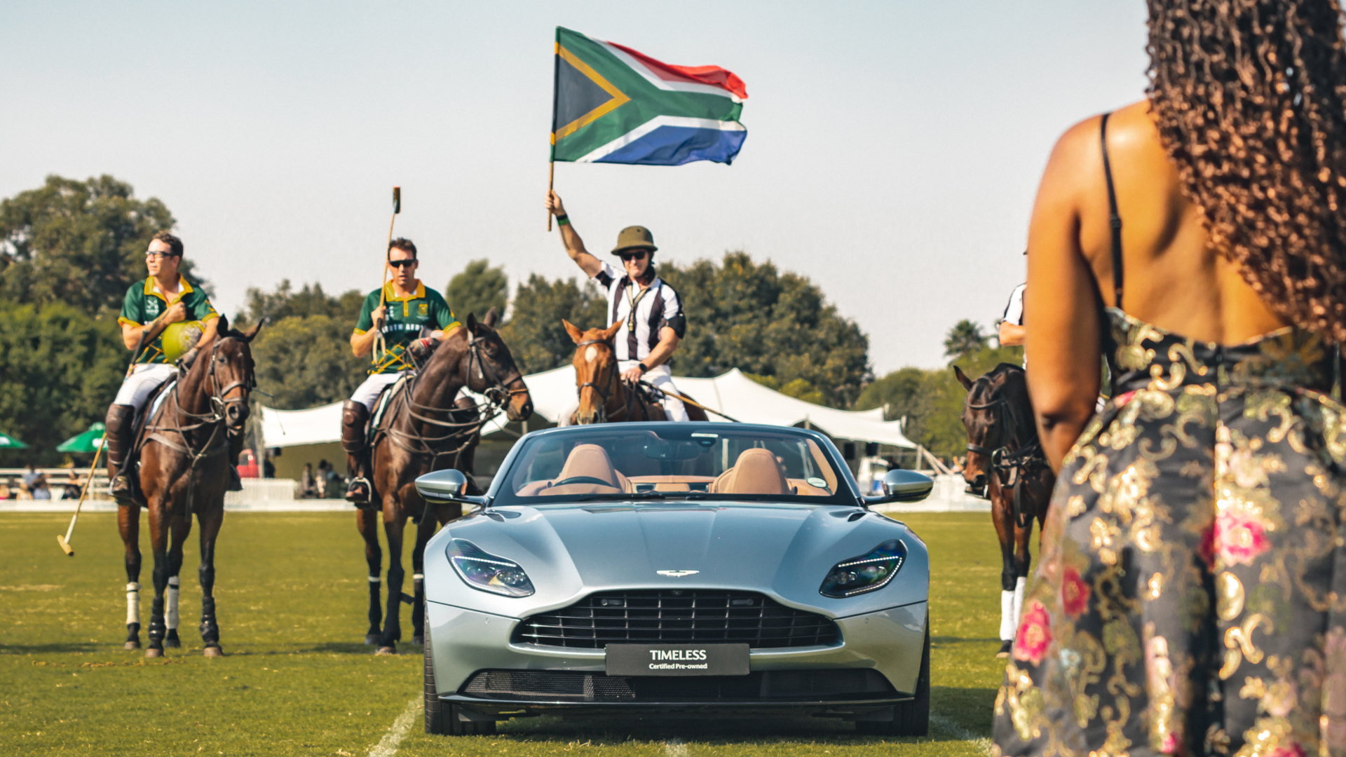 Silver Volante on the polo field as a rider raises the South African flag
